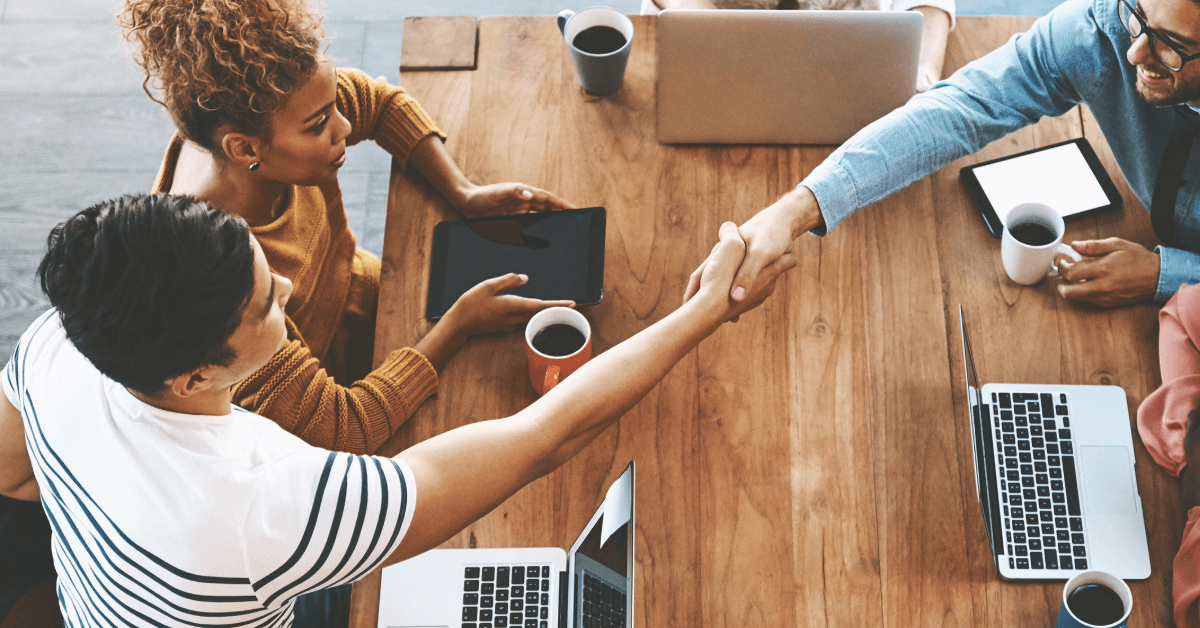 Handshake across a table
