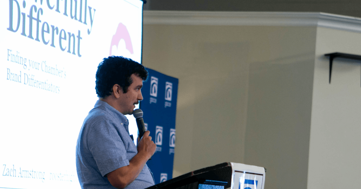 Zach speaking on stage at a conference.